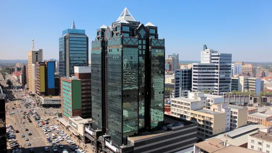 Daytime view of central Harare with modern high-rise buildings and busy traffic