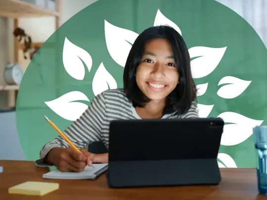 A homeschooling female student with short black hair studying at her bedroom desk, smiling at the camera.