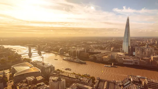 Golden hour skyline of London featuring the Shard and River Thames