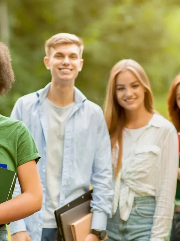GCSE Level students in a row smiling towards the camera.