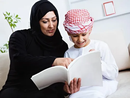 Mother supporting her son’s learning at home in UAE, showing the benefits of parent-led education with structure