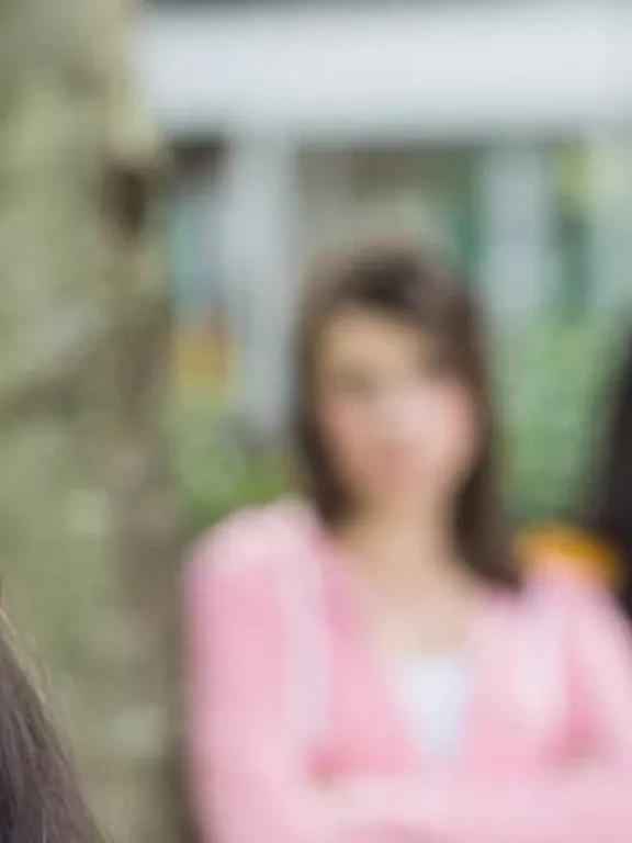 Teenage girl being excluded from the group and being laughed at by her peers.