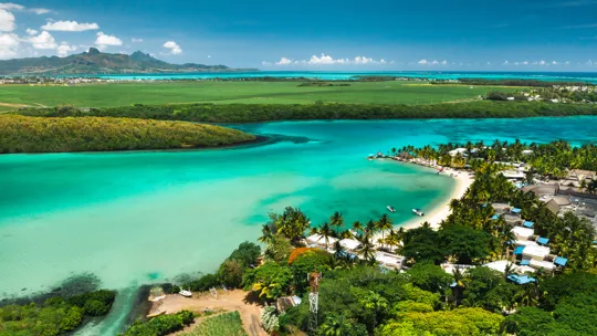 Aerial view of turquoise lagoon and palm-fringed coastline in Mauritius