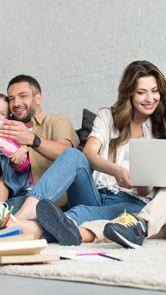 A family with two young children learning together at home, enjoying the flexibility of online education.