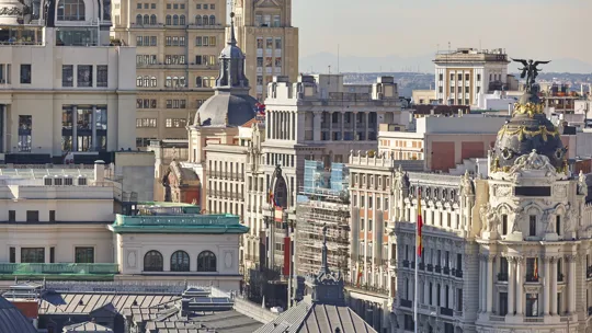 Aerial view of ornate historic buildings in central Madrid, Spain, under clear skies