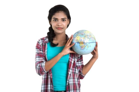 IGCSE Geography student with globe