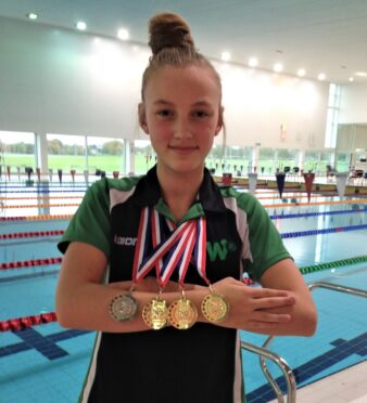 Swimmer Aimee Monks displaying her medals
