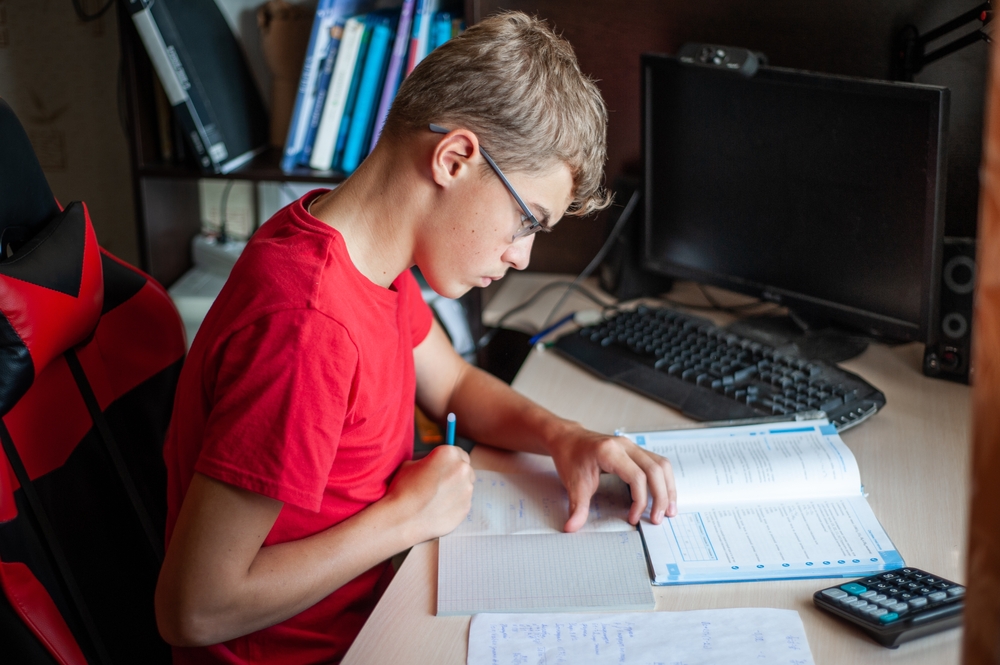 Young boy homeschooling in Poland