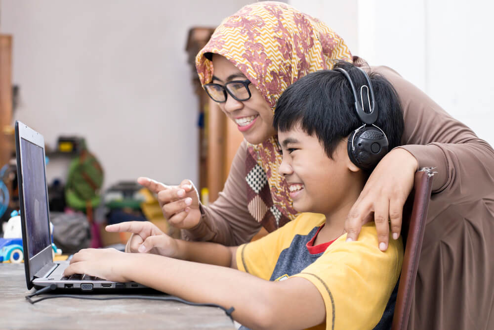 Young boy homeschooling in Jakarta